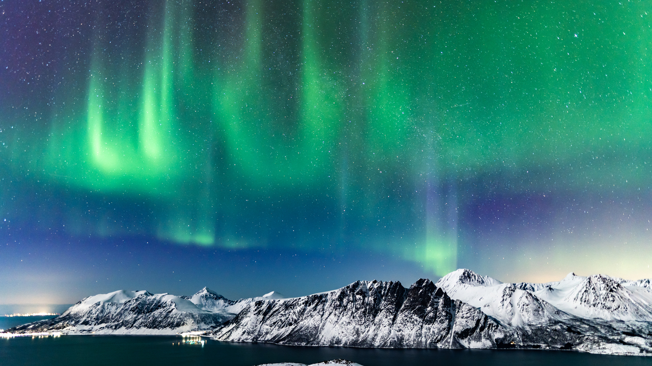 The aurora borealis over mountains in Harstad, northern Norway.