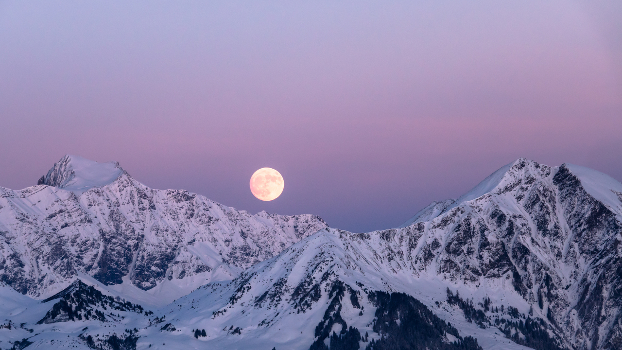 Image of a Full Moon rising over the Swiss Alps.