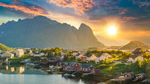 Solnedgang over hus og fjell i Lofoten, Norge.