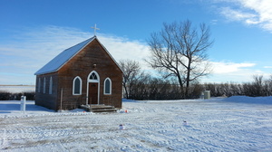 An old, tiny church on the cold snowy Prairies, Alberta, Canada.