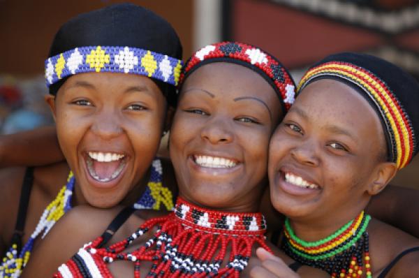 Three young Zulu women friends, dressed in traditional beaded Zulu 