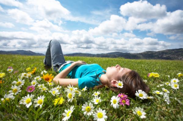 Girl day-dreaming in meadow