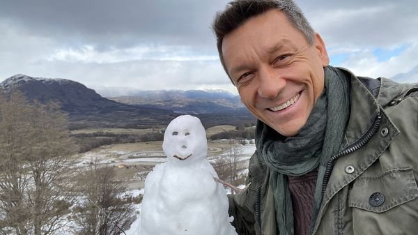 Our eclipse partner, Thomas H. Puzia, in the Chilean mountains next to a small snowman.
