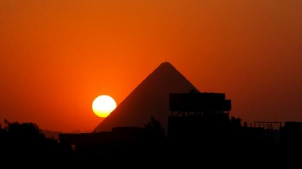 Sunset behind the pyramid of Cheops