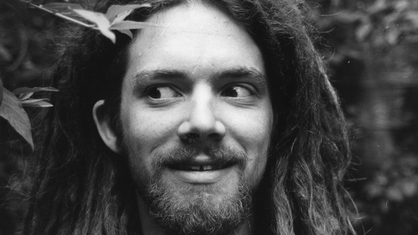 Smiling young man with dreadlocks and beard