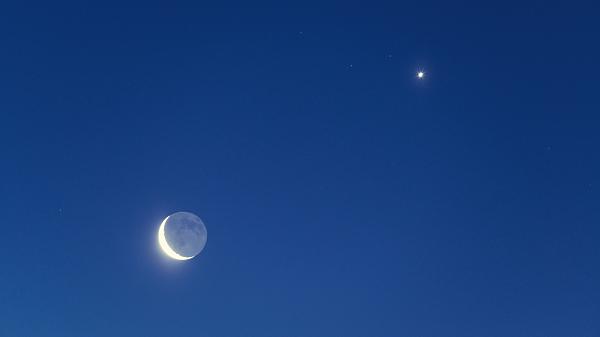 The Waning Crescent Moon with bright earthshine along with bright Venus in pre-dawn skies.