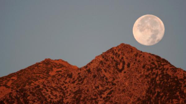 The Full Moon setting over Jobs Peak, Carson Valley, Nevada.