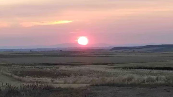 The Sun sets behind the Montes de León (the Mountains of León) in northwestern Spain.