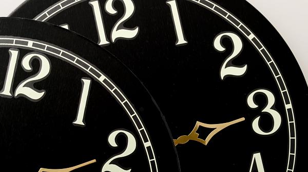 Two clock faces showing hours to adjust your clocks for Daylight Saving time.