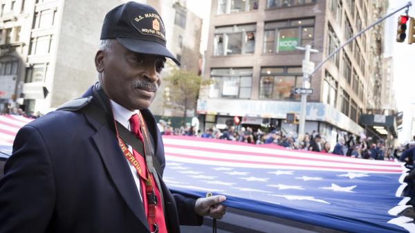 Vets and military personnel carry a large American flag in the annual parade up 5th Avenue on Veterans Day in Manhattan, New York.