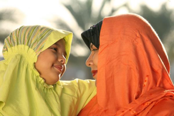 Muslim child and mother expressing joy.