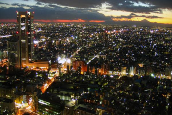 Twilight view over Tokyo metropolis with Mount Fuji on the horizon, back lighten by sun.