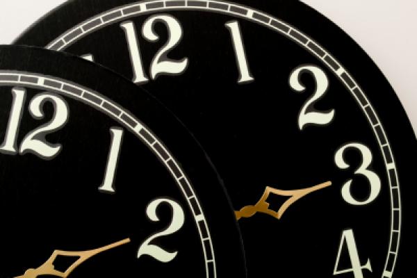 Two clock faces showing hours to adjust your clocks for Daylight Saving time.