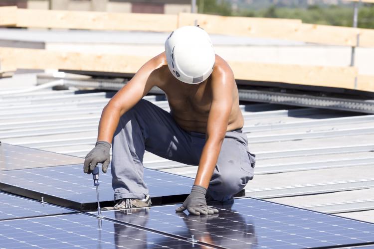 Man installing solar panels. Click to see more detail. Man installing solar panels.
