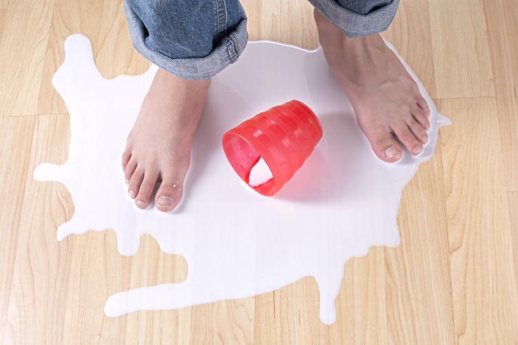 Person standing in a puddle of spilled milk.