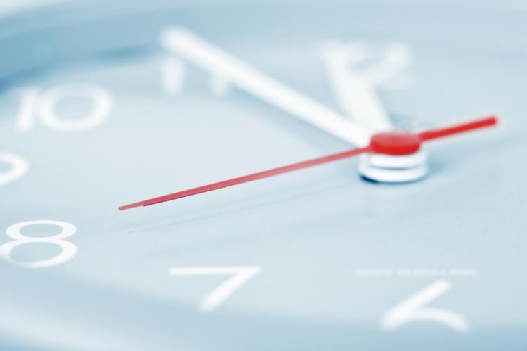 Part of clock with a close-up of a red pointer
