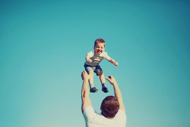Happy father and child having fun outdoors.