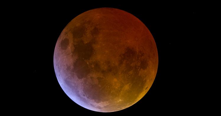 A totally eclipsed Moon against a black night sky