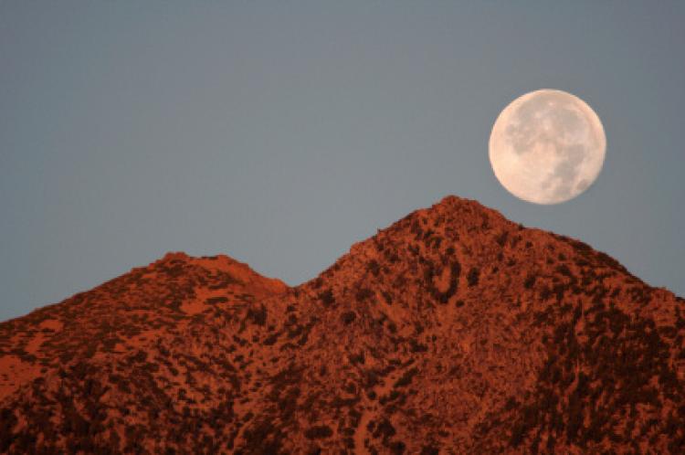 Full moon setting over Jobs Peak, Carson Valley, Nevada.