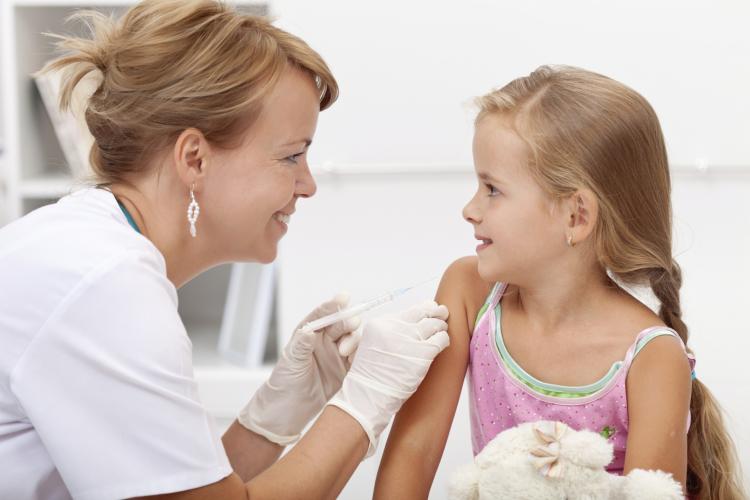School nurse administering an injection to a child. Click to see more detail. School nurse administering an injection to a child.