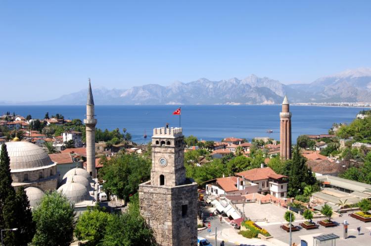 Clock tower and minaret in downtown Antalya Turkey.
