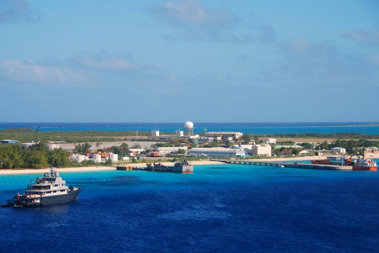Aerial view of an island surrounded by clear blue ocean.