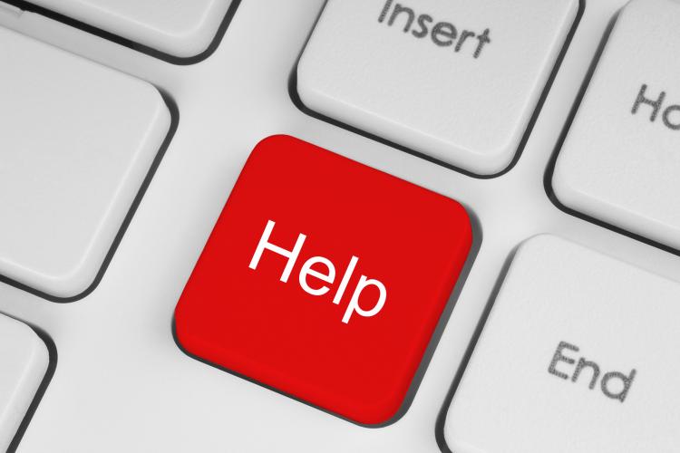 Keyboard with red button with help written on it.