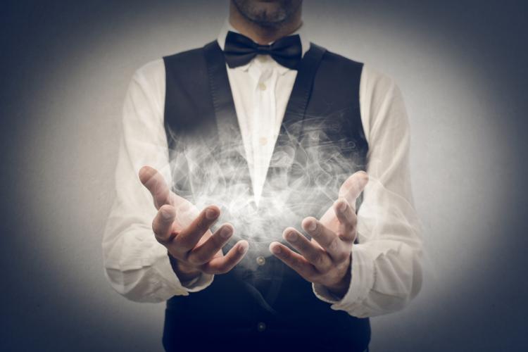 A magician with smoke in his hands.