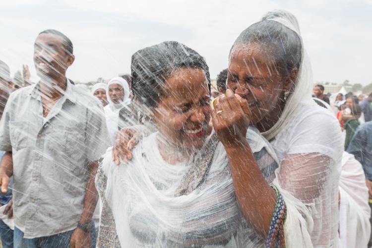 Holy water is sprayed onto the crowd attending Timkat celebrations of Epiphany commemorating the baptism of Jesus on January 19 2014 in Addis Ababa.