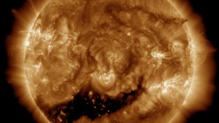 An image of the Sun taken by NASA's Solar Dynamics Observatory (SDO), showing a large, dark coronal hole near the solar equator on June 13, 2025.