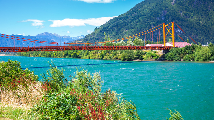 Orange bridge over the river at Puerto Aysen, Chile.