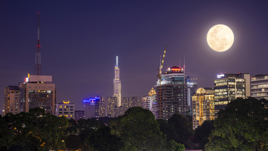Skyscraper in Ho Chi Minh City, Vietnam, under a Full Moon.