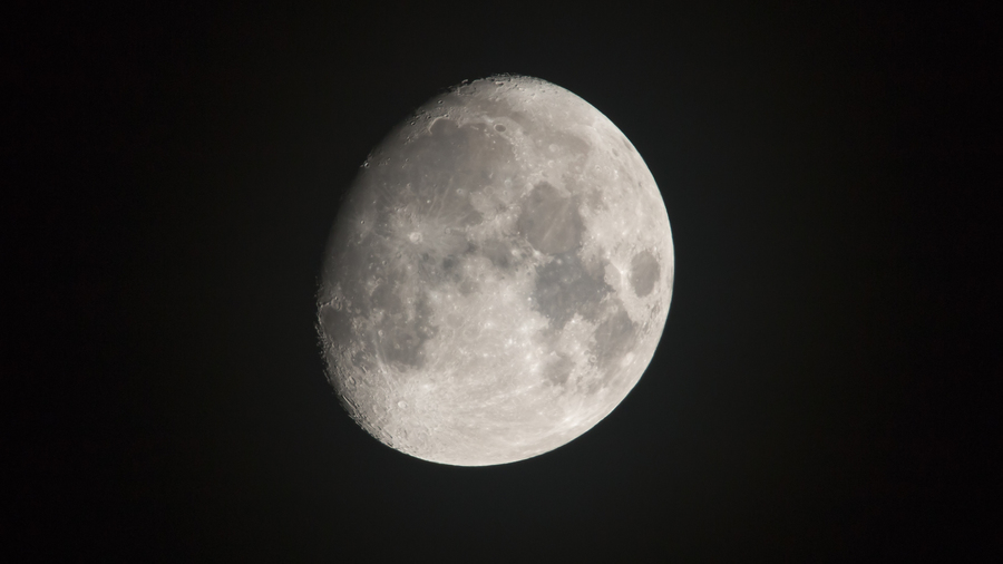 A Waxing Gibbous Moon against a black sky. A Waxing Gibbous Moon against a black sky.