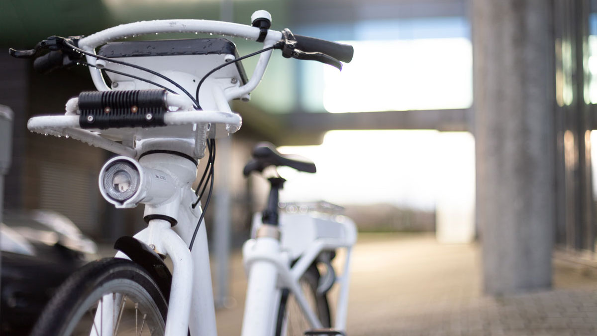 Close-up of a white electric city bike.