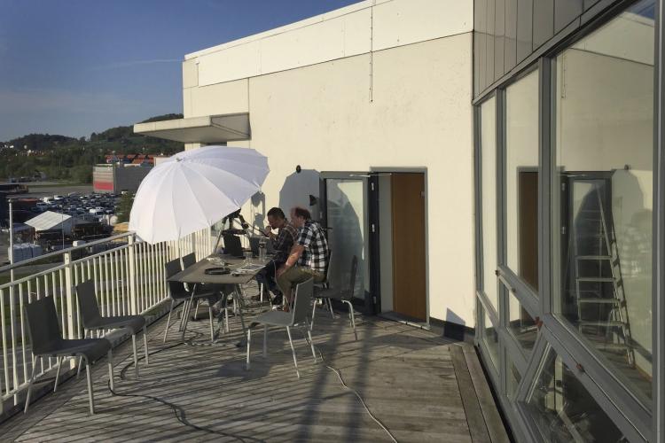 Image of timeanddate employees streaming an eclipse from the office balcony.