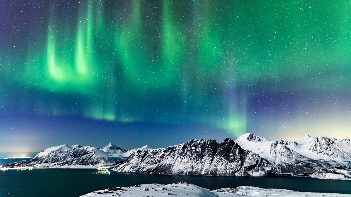 The aurora borealis over mountains in Harstad, northern Norway.