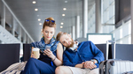 A young couple relaxing in an airport lounge.