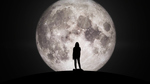 Silhouette of a woman against a large full Moon in the background.