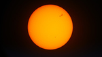 Photo of the sun with sunspots visible in its northern hemisphere.