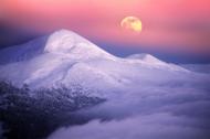 Moonrise over alpine peaks in Utah.