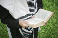 A Jewish man praying with a tallis (prayer shawl).
