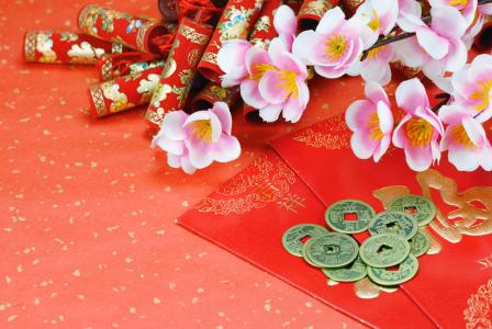 Studio shot of red envelope with money and chinese lunar new year decoration