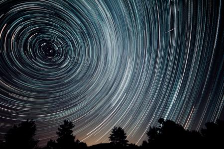 Dark sky at night with star trails.