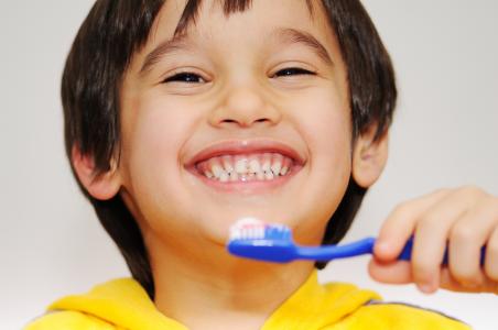 Kid brushing teeth.