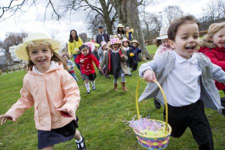 Happy children running during an Easter egg hunt.