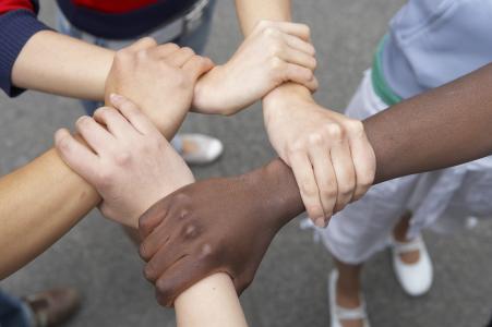 Many hands holding onto each other.