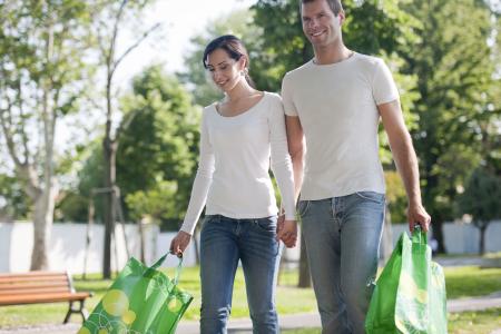 Young couple with reusable bags.