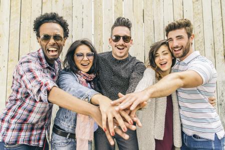 Group of people smiling and cheering.