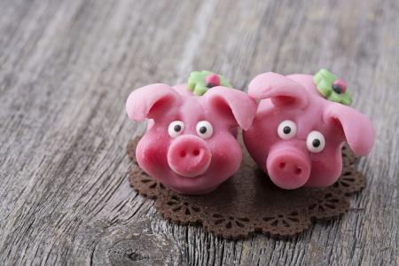 Close-up of two pink marzipan pigs.