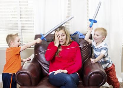 Young mother overwhelmed by her kids.